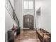 View of the home's foyer area with hardwood floors, high ceilings, and a staircase at 621 Foxboro Dr, Avon, IN 46123
