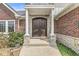 Close up of the stately stone and brick front door entry featuring a covered porch with columns at 621 Foxboro Dr, Avon, IN 46123