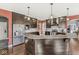 Modern kitchen features dark cabinetry, granite countertops, stainless steel appliances, and pendant lighting at 621 Foxboro Dr, Avon, IN 46123