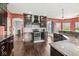 Kitchen featuring dark cabinets, granite counters, hardwood floors, and stainless appliances at 621 Foxboro Dr, Avon, IN 46123