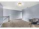 Cozy carpeted landing area with staircase and comfortable seating at 621 Foxboro Dr, Avon, IN 46123