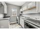 Laundry room with cabinetry, a sink, counter space, and updated appliances at 621 Foxboro Dr, Avon, IN 46123