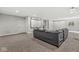 Spacious living room featuring a large screen, plush carpet, neutral walls, and modern lighting creates a relaxing space at 621 Foxboro Dr, Avon, IN 46123