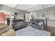 Bright living room with coffered ceiling, gray sofas and an overhead view of the kitchen at 621 Foxboro Dr, Avon, IN 46123