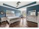 A stylish primary bedroom features wood floors, neutral furniture and decor, with views of the backyard at 621 Foxboro Dr, Avon, IN 46123