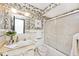 Bathroom features patterned wallpaper, mirrored vanity, and shower-tub combo at 6454 Dean Rd, Indianapolis, IN 46220