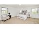 Bright bedroom with two windows, soft carpet, and a comfortable bed at 6454 Dean Rd, Indianapolis, IN 46220