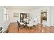 Bright dining room with modern light fixture, hardwood floors, and minimalist decor at 6454 Dean Rd, Indianapolis, IN 46220