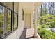 Covered porch area showcasing a brick floor and verdant landscaping at 6454 Dean Rd, Indianapolis, IN 46220