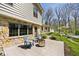 Exterior patio featuring chairs, a modern fire pit, and verdant landscaping at 6454 Dean Rd, Indianapolis, IN 46220