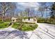 Exterior view showcasing the attached garage, stone accents, and lush landscaping at 6454 Dean Rd, Indianapolis, IN 46220