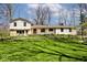Inviting home exterior featuring stone accents, a spacious yard, and meticulous landscaping at 6454 Dean Rd, Indianapolis, IN 46220