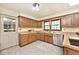 Updated kitchen featuring a stainless steel dishwasher, oak cabinets, and neutral countertops at 6454 Dean Rd, Indianapolis, IN 46220