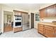 Well-equipped kitchen with stainless steel appliances, oak cabinets, and access to the dining area at 6454 Dean Rd, Indianapolis, IN 46220