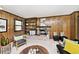 Cozy living room with wood paneling, stone fireplace, and built-in bookshelves at 6454 Dean Rd, Indianapolis, IN 46220