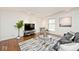 Comfortable living room featuring hardwood floors, lots of natural light, and modern decor at 6454 Dean Rd, Indianapolis, IN 46220