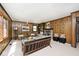 Spacious living room features wood paneling, a stone fireplace, and plush seating at 6454 Dean Rd, Indianapolis, IN 46220