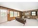 Sunlit living room boasts wood paneling, large windows, and comfortable seating at 6454 Dean Rd, Indianapolis, IN 46220