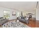 Inviting living room with hardwood floors, many windows, and an open floor plan at 6454 Dean Rd, Indianapolis, IN 46220