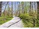 Gravel walking path meanders through a wooded area on the property at 6454 Dean Rd, Indianapolis, IN 46220