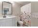 Clean and well-maintained bathroom with a single sink vanity, large mirror, and decorative floral shower curtain at 6516 Emerald Hill Ct # 310, Indianapolis, IN 46237