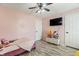 Cozy pink bedroom with a television, toy chest, and neutral flooring at 6516 Emerald Hill Ct # 310, Indianapolis, IN 46237