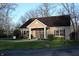 Charming brick clubhouse with well-maintained landscaping, complemented by mature trees and ample natural light at 6516 Emerald Hill Ct # 310, Indianapolis, IN 46237