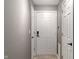 Inviting entryway features a smart lock on the front door and neutral gray walls at 6516 Emerald Hill Ct # 310, Indianapolis, IN 46237