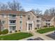 Exterior of complex with balconies, manicured lawn, and nearby parking at 6516 Emerald Hill Ct # 310, Indianapolis, IN 46237