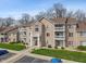 Exterior of complex showing balconies, well-maintained landscaping, and ample parking at 6516 Emerald Hill Ct # 310, Indianapolis, IN 46237
