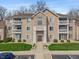 Charming condo building featuring a manicured lawn, complemented by private balconies on each level at 6516 Emerald Hill Ct # 310, Indianapolis, IN 46237