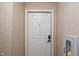 Condo front door featuring secure smart lock, a peephole and a fire extinguisher nearby at 6516 Emerald Hill Ct # 310, Indianapolis, IN 46237