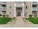 Inviting condo entrance features large, white pillars, a well-manicured lawn, and easy access to numbered units at 6516 Emerald Hill Ct # 310, Indianapolis, IN 46237