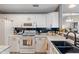 Bright kitchen with white cabinets, black backsplash, modern appliances, and ample counter space for cooking prep at 6516 Emerald Hill Ct # 310, Indianapolis, IN 46237