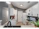 Bright, modern kitchen with white cabinets, stainless steel appliances, and a pass-through to the dining area at 6516 Emerald Hill Ct # 310, Indianapolis, IN 46237