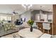 Open-concept living room boasts natural light, modern furnishings, and seamless flow to the kitchen and outdoor balcony at 6516 Emerald Hill Ct # 310, Indianapolis, IN 46237