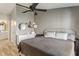 Spacious main bedroom features hardwood floors, a ceiling fan, and an ensuite bathroom at 6516 Emerald Hill Ct # 310, Indianapolis, IN 46237