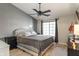 Calm main bedroom with a ceiling fan, large bed, and lots of natural light from the large window at 6516 Emerald Hill Ct # 310, Indianapolis, IN 46237