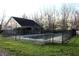Fenced in pool area with green grass and trees behind the building at 6516 Emerald Hill Ct # 310, Indianapolis, IN 46237