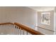 The building's stairwell is illuminated by a chandelier and expansive window at 6516 Emerald Hill Ct # 310, Indianapolis, IN 46237