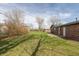 A large backyard and partial view of a red brick home at 652 E Tilden Dr, Brownsburg, IN 46112