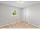 Bedroom showcasing a closet, gray walls, laminate flooring, and a window in a bright setting at 652 E Tilden Dr, Brownsburg, IN 46112