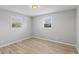 Bedroom showing gray walls, laminate flooring, and two windows in a tranquil space at 652 E Tilden Dr, Brownsburg, IN 46112