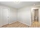 Bedroom showing gray walls, laminate flooring, a closet, and a door to the bathroom at 652 E Tilden Dr, Brownsburg, IN 46112