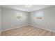 Cozy bedroom featuring two windows, gray walls, laminate flooring, and ample natural light at 652 E Tilden Dr, Brownsburg, IN 46112