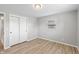 Bedroom displaying a closet, gray walls, laminate flooring, and a window in a peaceful setting at 652 E Tilden Dr, Brownsburg, IN 46112