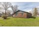 A charming brick house sits on a lush green lawn, showcasing its simple beauty at 652 E Tilden Dr, Brownsburg, IN 46112