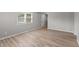 Bright living room features modern floors, neutral walls and natural light from two windows at 652 E Tilden Dr, Brownsburg, IN 46112