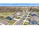 A high-angle shot displays a scenic neighborhood with trees and manicured lawns surrounding attractive homes at 6622 Cardiff Cir, McCordsville, IN 46055