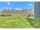 Backyard with green lawn, fence, and seating area with fire pit, ideal for outdoor enjoyment and relaxation at 6622 Cardiff Cir, McCordsville, IN 46055